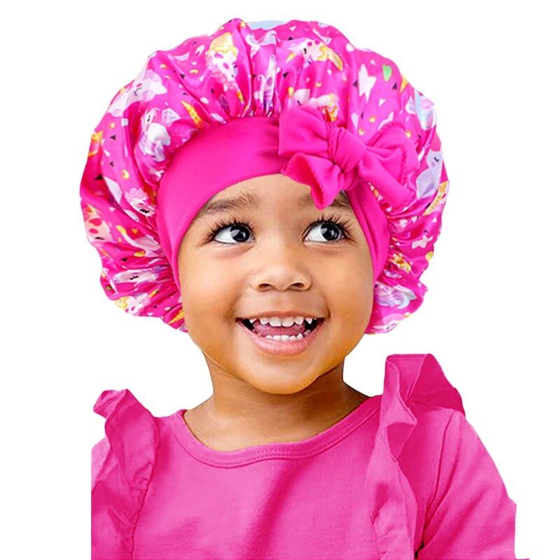New Kids Unicorn Satin Bonnet with Wide Elastic Band and Ribbon, Perfect for Curly and Natural Hair, Perfect as a Nightcap, Shower Cap, or Headscarf. One Size; Imported.