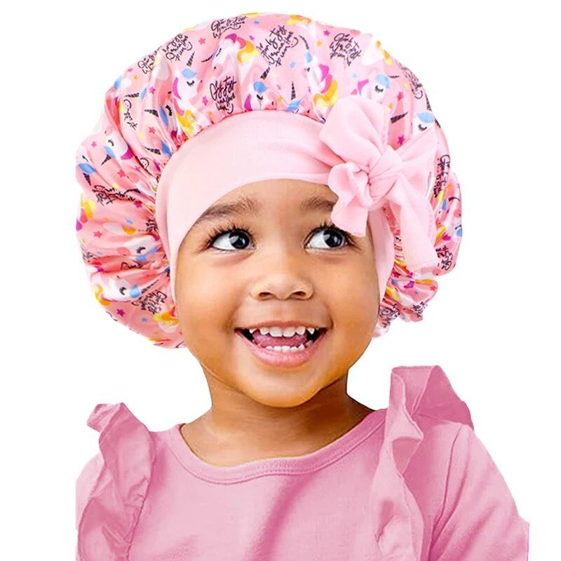 New Kids Unicorn Satin Bonnet with Wide Elastic Band and Ribbon, Perfect for Curly and Natural Hair, Perfect as a Nightcap, Shower Cap, or Headscarf. One Size; Imported.