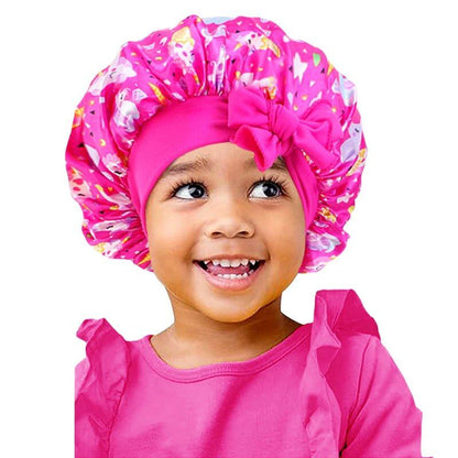 New Kids Unicorn Satin Bonnet with Wide Elastic Band and Ribbon, Perfect for Curly and Natural Hair, Perfect as a Nightcap, Shower Cap, or Headscarf. One Size; Imported.
